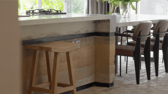 awan kuning terrace house OTCQ Architects green facade plants architecture interior design greenery oscar tan design seed biophilic biophilic house green house dining kitchen countertop rammed earth countertop