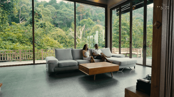 floating treehouse nature forest open to forest house eco friendly green family retreat forest view family home wooden design interior design architecture design seed inch lim inchscape elderly couple mature couple retirement home relax relaxing inch lim inchscape designer architect rubber estate forest jungle Malaysia woman looking at forest forest scenery nature beautiful homes green homes front door entrance pond asian house ceiling living room grey sofa low sofa wooden table wooden furniture wooden living room